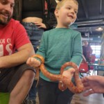 Brayden holding a snake at Cognitions in Beulah Michigan